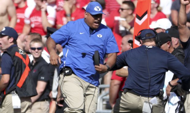 Brigham Young Cougars head coach Kalani Sitake and the BYU sideline explode with excitement after a...