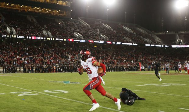 Utah Utes wide receiver Samson Nacua (45) makes a catch and run for a touchdown as Utah goes on to ...