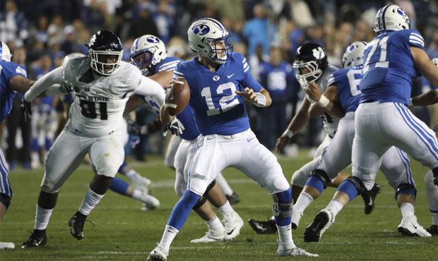 Brigham Young Cougars quarterback Tanner Mangum (12) looks to throw during the Utah State versus BY...