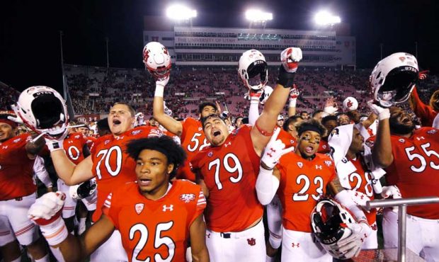 The Utah Utes celebrate after defeating the USC Trojans in NCAA football in Salt Lake City on Satur...