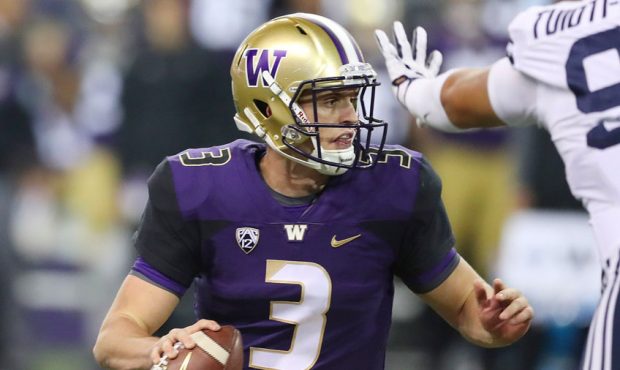 Washington Huskies quarterback Jake Browning (3) looks to pass against the Brigham Young Cougars in...