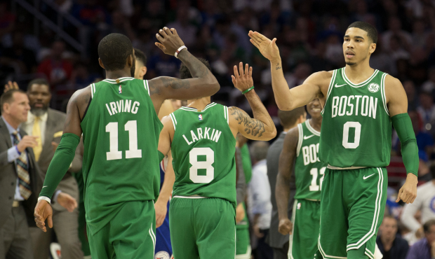 PHILADELPHIA, PA - OCTOBER 20: Jayson Tatum #0 of the Boston Celtics high fives Kyrie Irving #11 an...