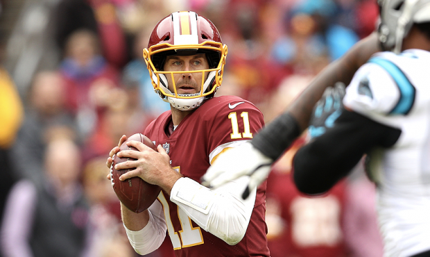 LANDOVER, MD - OCTOBER 14: Quarterback Alex Smith #11 of the Washington Redskins looks to throw the...