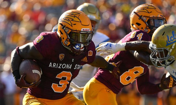 Running back Eno Benjamin #3 of the Arizona State Sun Devils carries the football in the second hal...