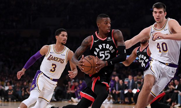 Delon Wright #55 of the Toronto Raptors drives to the basket as he is chased by Ivica Zubac #40 and...