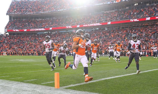 Running back Devontae Booker #23 of the Denver Broncos runs into the end zone with a second quarter...