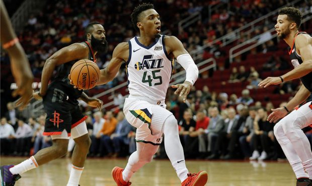 HOUSTON, TX - OCTOBER 24: Donovan Mitchell #45 of the Utah Jazz drives to the basket defended by Mi...