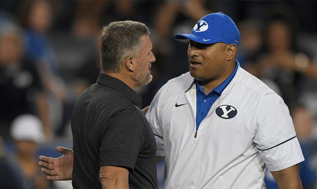 Head coach Kyle Whittingham of the Utah Utes and head coach Kalani Sitake of the Brigham Young Coug...