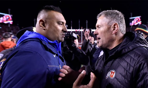 Head coach Kalani Sitake of the Brigham Young Cougars meets with head coach Kyle Whittingham of the...