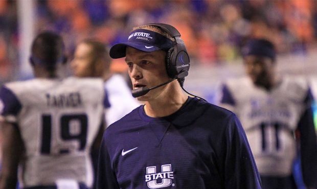 Head coach Matt Wells of the Utah State Aggies talking with his team during second half action agai...