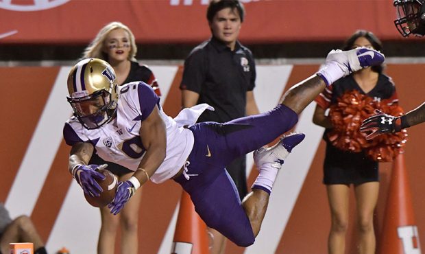 Myles Gaskin #9 of the Washington Huskies leaps into the end zone for a touchdown in the first half...