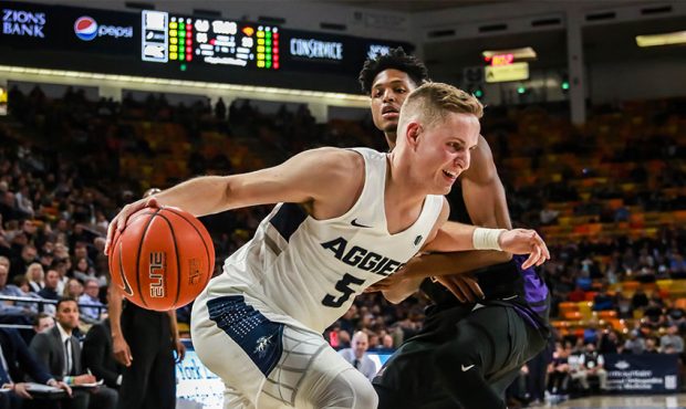 Utah State's Sam Merrill (5) drives to the basket against Northern Iowa at the Dee Glen Smith Spect...