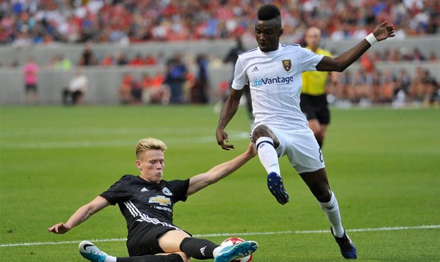 Scott Mctominay #39 of Manchester United directs the ball away from Sunday Stephen #8 of Real Salt ...