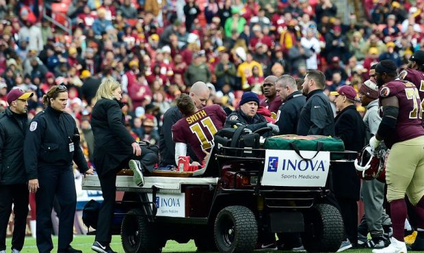 LANDOVER, MD - NOVEMBER 18: Alex Smith #11 of the Washington Redskins is helped off the field after...
