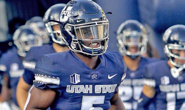 Utah State running back Darwin Thompson (5) runs onto the field prior to the start of USU's game ag...