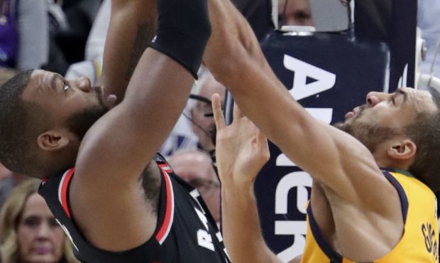 Toronto Raptors center Greg Monroe (15) and Utah Jazz center Rudy Gobert (27) reach for the rebound...