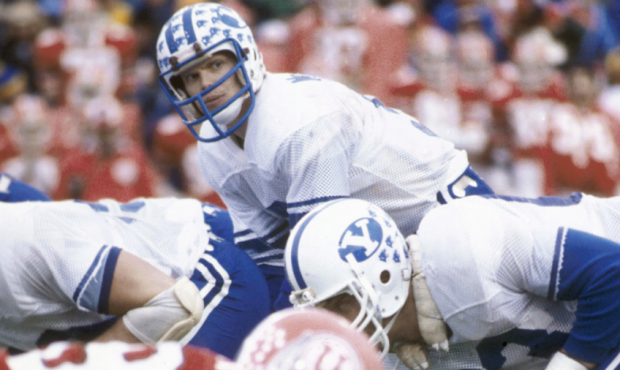 Brigham Young University quarterback Jim McMahon overlooks the University of Utah defense during a ...