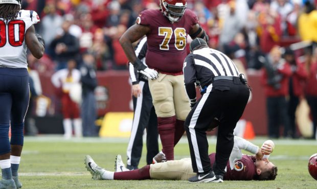 LANDOVER, MD - NOVEMBER 18: Alex Smith #11 of the Washington Redskins lays on the field after being...