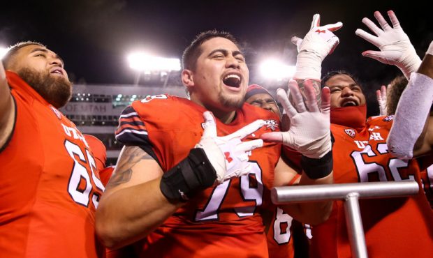 Utah Utes offensive lineman Jordan Agasiva (79) and teammates celebrate and flash the number eight,...