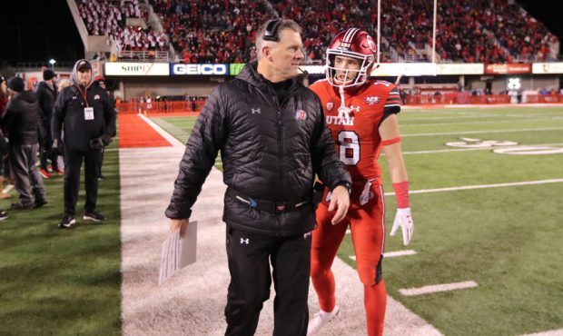 Utah Utes head coach Kyle Whittingham and Utah Utes wide receiver Britain Covey (18) talk in the fo...