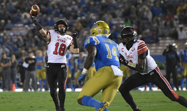 Britain Covey #18 of the Utah Utes throws a touchdown pass in the second quarter agaisnt UCLA Bruin...