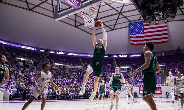 UVU's Jake Toolson goes up for a dunk against Weber State at the Dee Event Center in Ogden, Utah on...