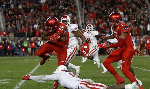 Joe Williams #28 of the Utah Utes jumps Jonathan Crawford #9 of the Indiana Hoosiers during the Fos...