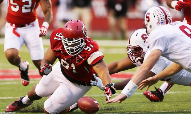 Tenny Palepoi #91 of the Utah Utes gathers in a fumble by Kevin Hogan #8 of the Stanford Cardinal d...