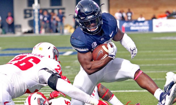 Utah State running back Darwin Thompson scores from three yards out during the Aggies' 61-19 victor...