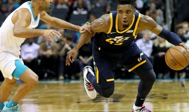 Donovan Mitchell #45 of the Utah Jazz drives to the basket against Tony Parker #9 of the Charlotte ...