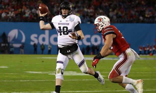 Clayton Thorson #18 of the Northwestern Wildcats attempts turnover pass as Cody Barton #30 of the U...