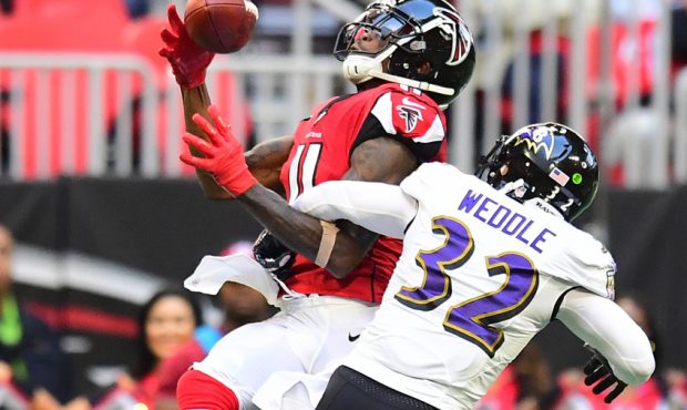 Eric Weddle #32 of the Baltimore Ravens breaks up a pass intended for Julio Jones #11 of the Atlant...