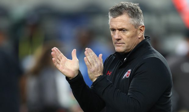Utah Utes head coach Kyle Whittingham claps is hands as he players stretch as Utah prepares to play...