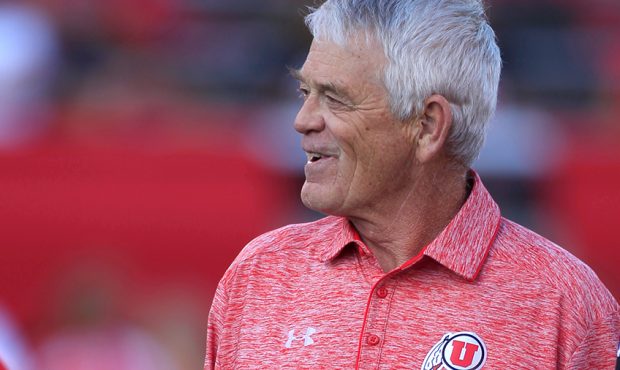 Assistant football coach, Dennis Erickson, of the Utah Utes, watches his players warm-up before a g...