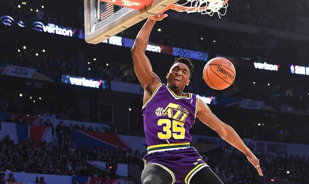 Donovan Mitchell #45 of the Utah Jazz dunks over Kevin Hart, Jordan Mitchell and Hendrix Hart in th...