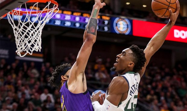 Utah Jazz guard Donovan Mitchell (45) throws down a huge dunk over Los Angeles Lakers center JaVale...