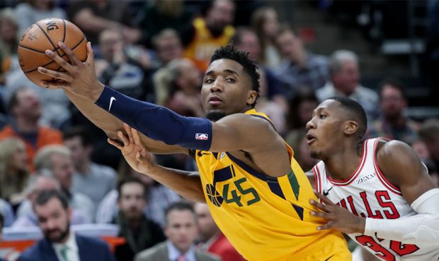 Utah Jazz guard Donovan Mitchell (45) is covered by Chicago Bulls guard Kris Dunn (32) during the g...