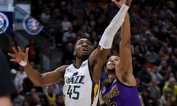 Utah Jazz guard Donovan Mitchell (45) scoops a shot over Los Angeles Lakers guard Josh Hart (3) dur...
