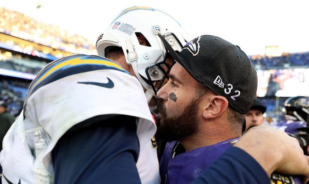 Philip Rivers #17 of the Los Angeles Chargers hugs Eric Weddle #32 of the Baltimore Ravens after th...