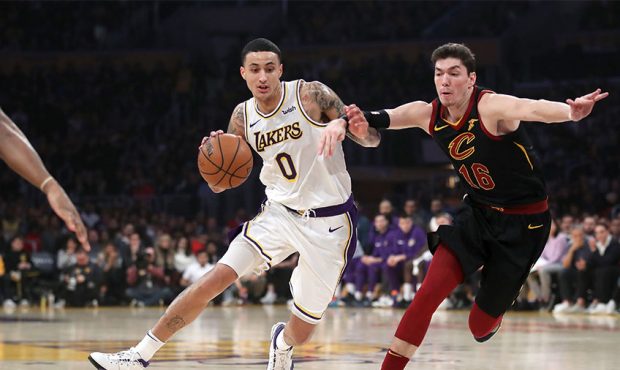 Kyle Kuzma #0 of the Los Angeles Lakers dribbles past Cedi Osman #16 of the Cleveland Cavaliers dur...