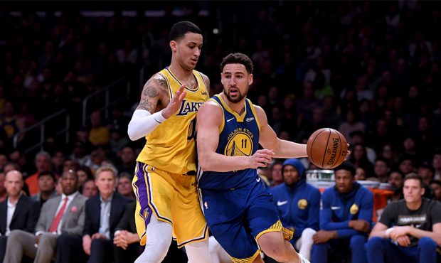 Klay Thompson #11 of the Golden State Warriors drives on Kyle Kuzma #0 of the Los Angeles Lakers du...
