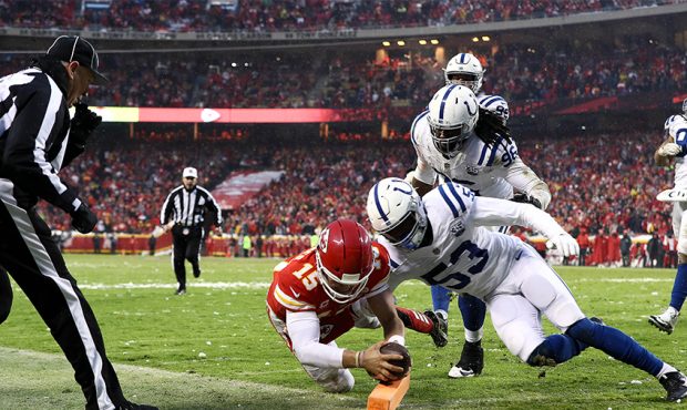 Patrick Mahomes #15 of the Kansas City Chiefs dives for the endzone to for a touchdown as Darius Le...