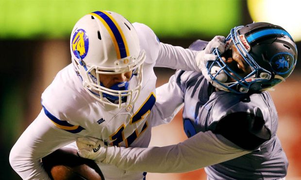 Orem's Puka Nacua is tackled by Sky View's Caleb Christensen as they play in 4A semifinal football ...