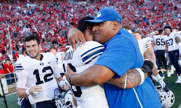 Head coach Kalani Sitake of the BYU Cougars celebrates with Sione Takitaki #16 after the game again...