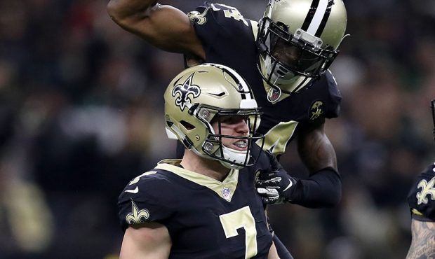 Taysom Hill #7 is congratulated by his teammate Justin Hardee #34 of the New Orleans Saints after s...