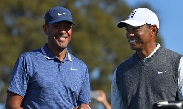 Tony Finau and Tiger Woods share a laugh on the South Course during the first round of the 2019 Far...