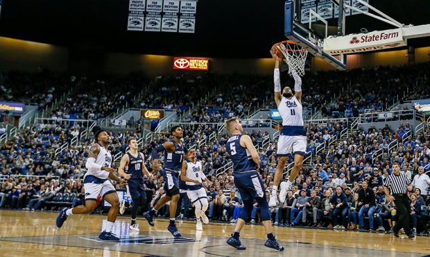 Cody Martin #11 of the Nevada Wolf Pack slams the ball into the basket to score again over the Utah...