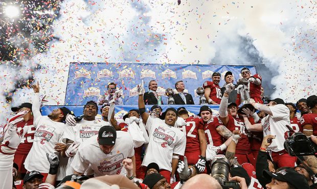 The Washington State Cougars celebrate during the trophy presentation after winning the Valero Alam...