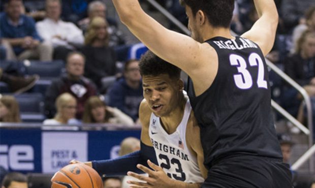 Brigham Young Cougars forward Yoeli Childs (23) drives to the hoop while guarded by Portland Pilots...