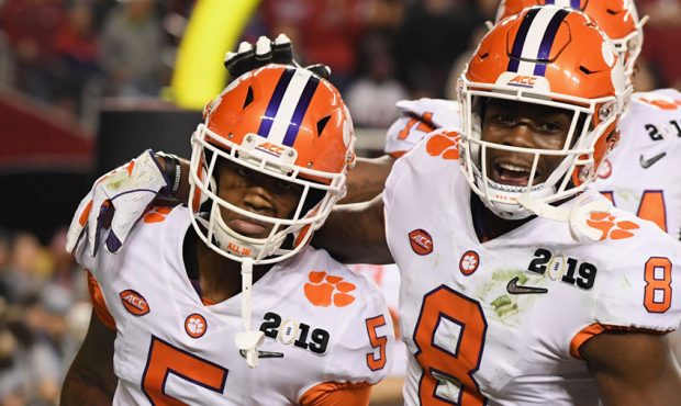 Tee Higgins #5 of the Clemson Tigers is congratulated by his teammate Justyn Ross #8 after his thir...